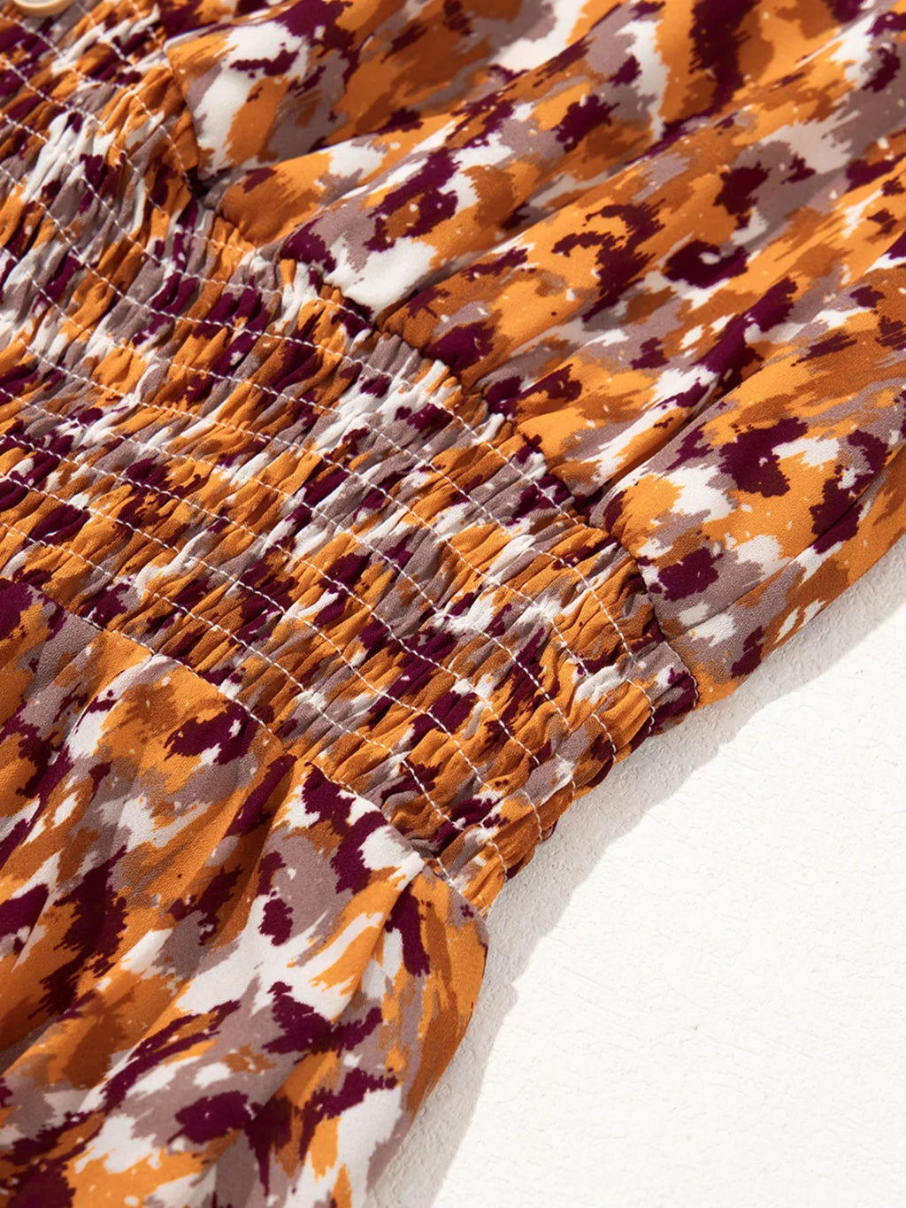 Abstract Print V Neck Smocked Babydoll Blouse