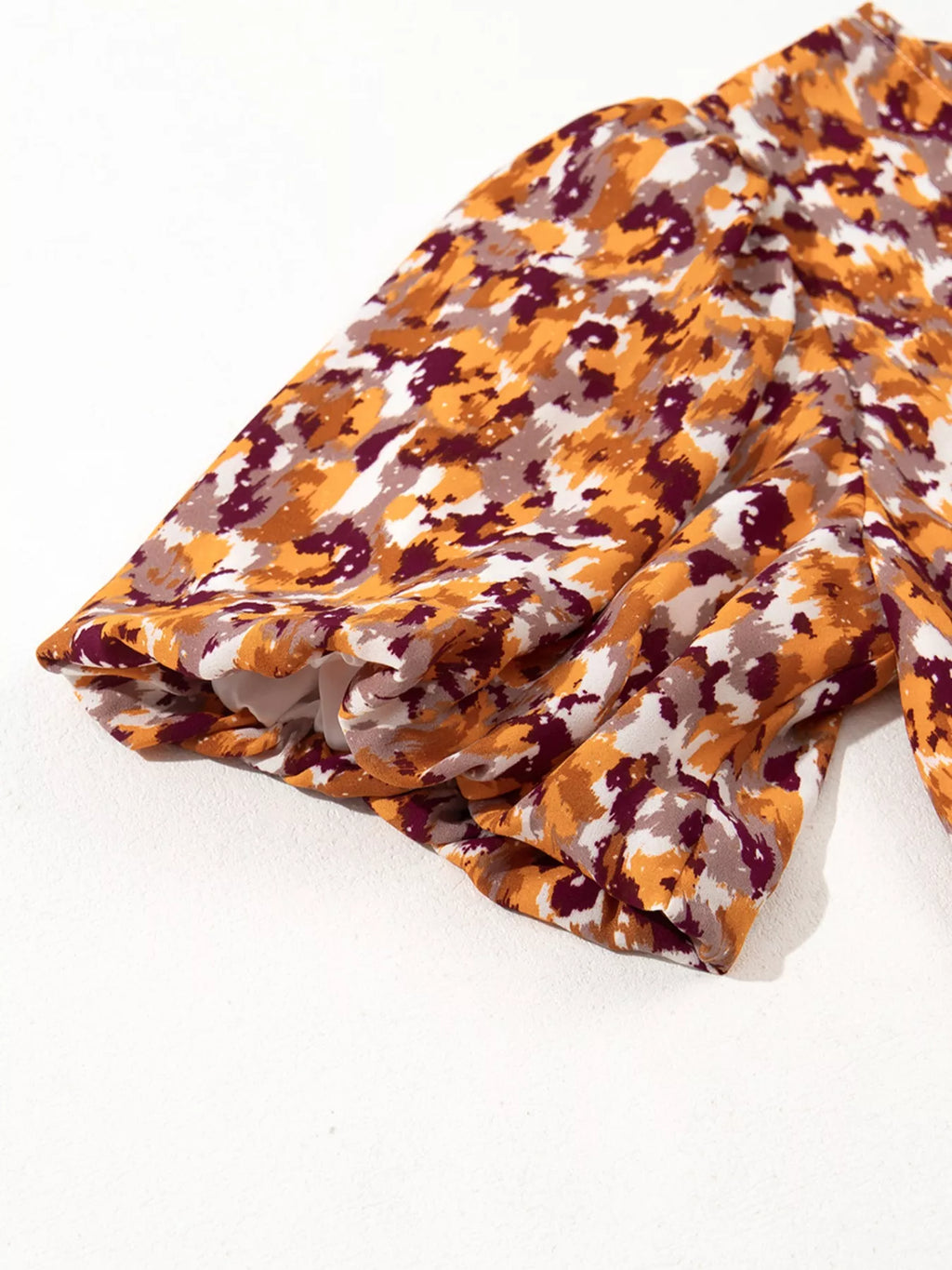 Abstract Print V Neck Smocked Babydoll Blouse